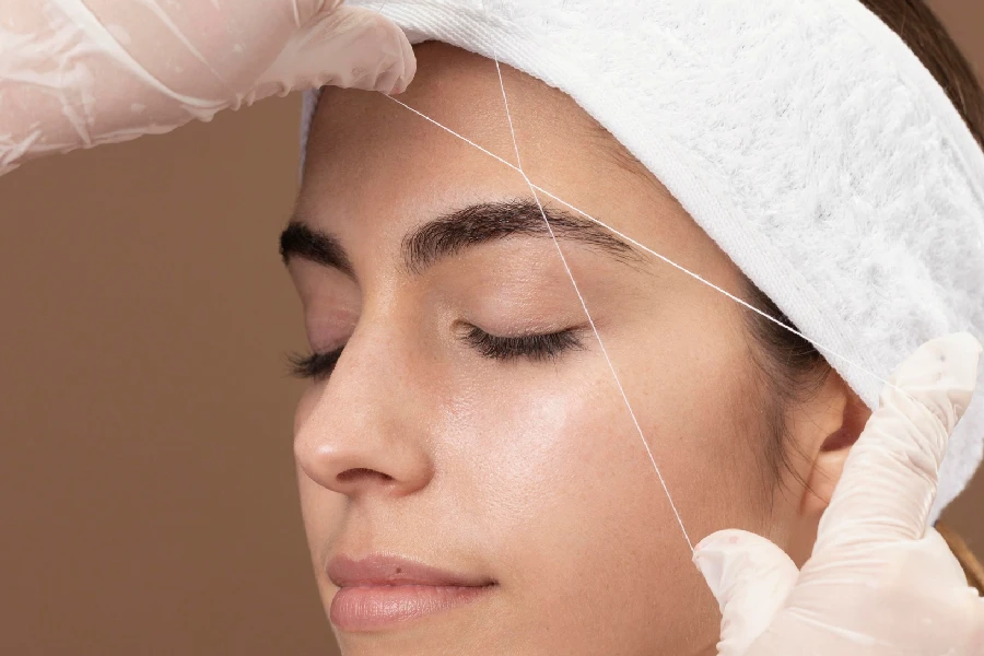 Eyebrow Threading in progress at Skin Kouture
